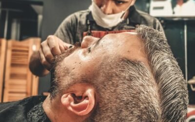 A barber skillfully provides a haircut and grooming at a modern barber shop, emphasizing professional care.