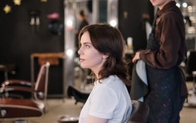 Woman receiving a haircut in a modern salon, stylist in focus.