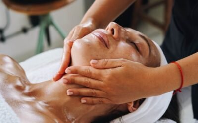 A woman enjoys a calming face massage at a spa, promoting relaxation and wellness.