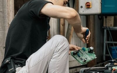 Outdoor scene of a technician repairing electrical equipment in an industrial area.