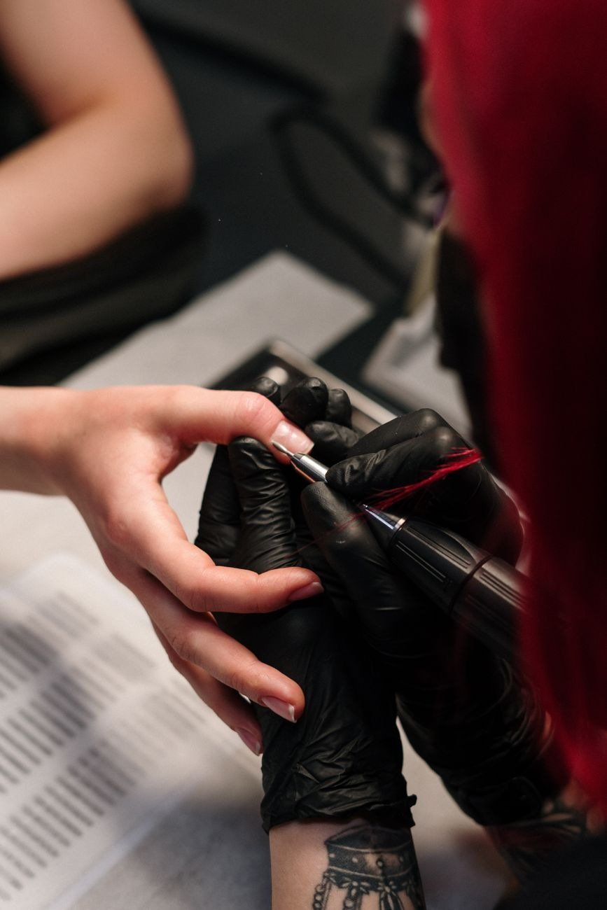 Close-up of a professional manicure session with a focus on nail art and detail.