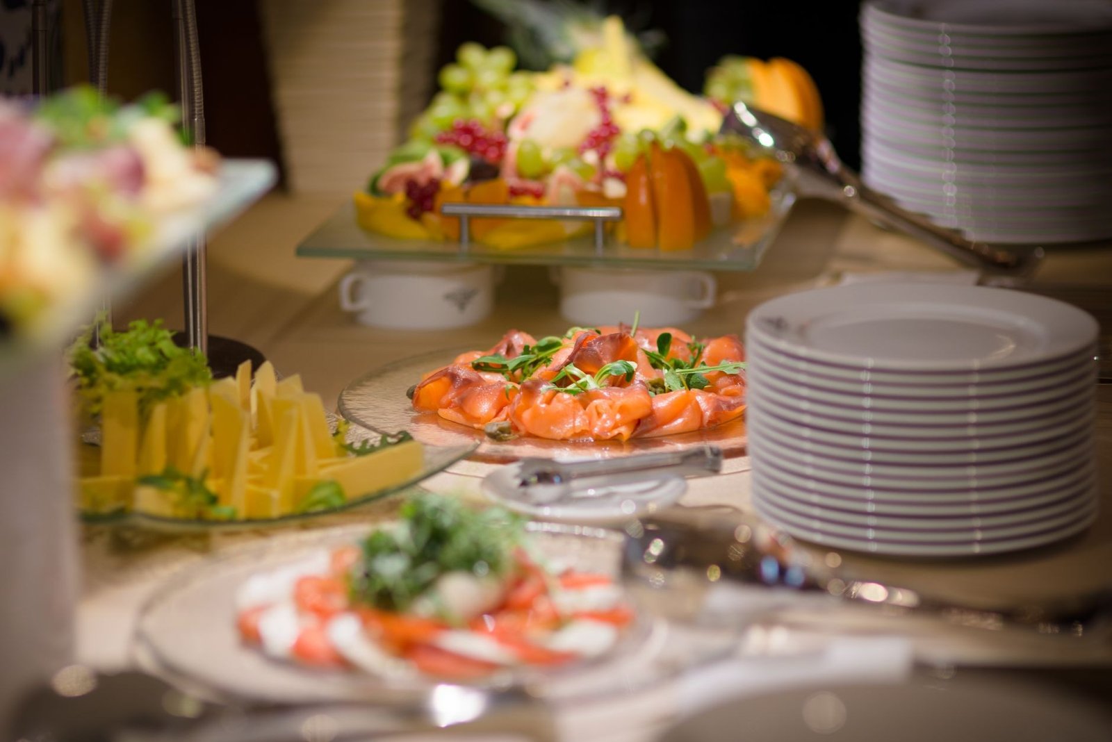 Luxurious buffet setting featuring smoked salmon, fresh fruits, and cheese platters.